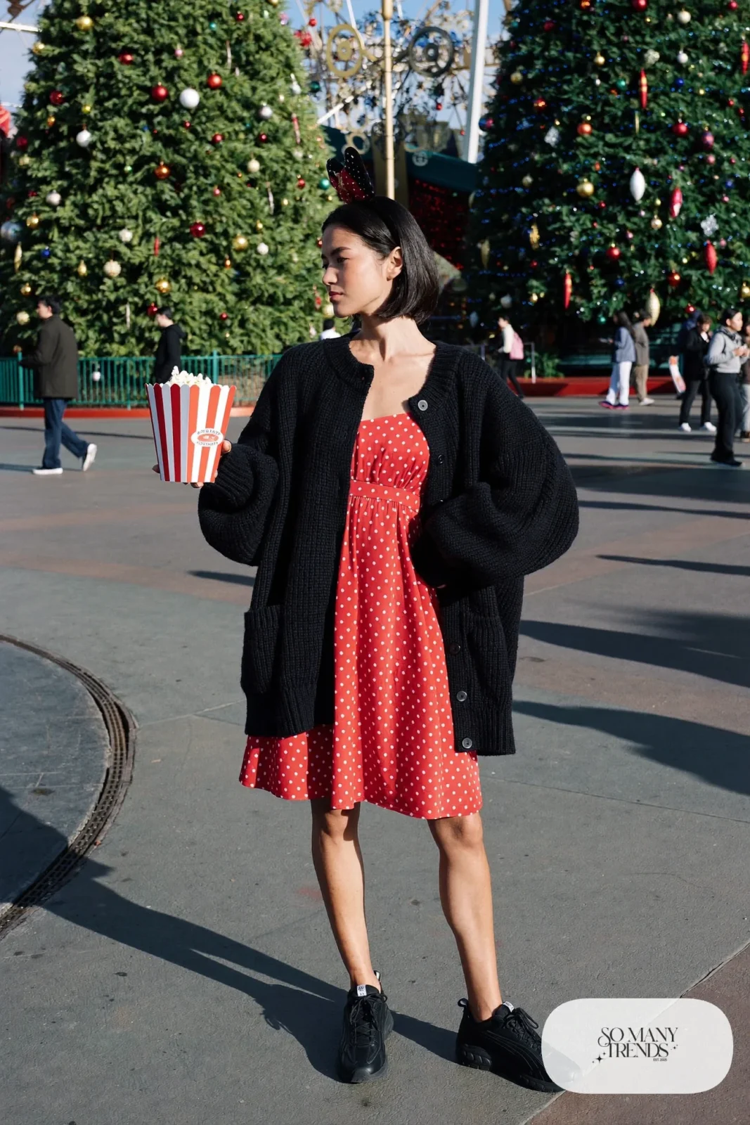 Red polka dot A-line dress with black cardigan, red bow headband and black sneakers, outfit 2