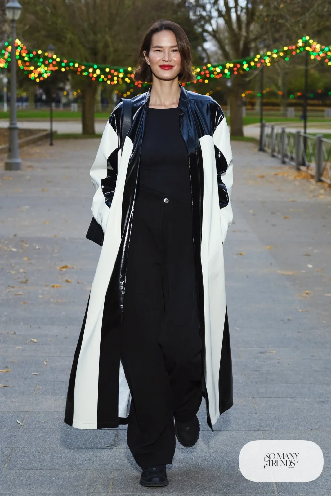 Black and white color-block swing coat over black tee and wide-leg black pants with chunky black sneakers, outfit 4