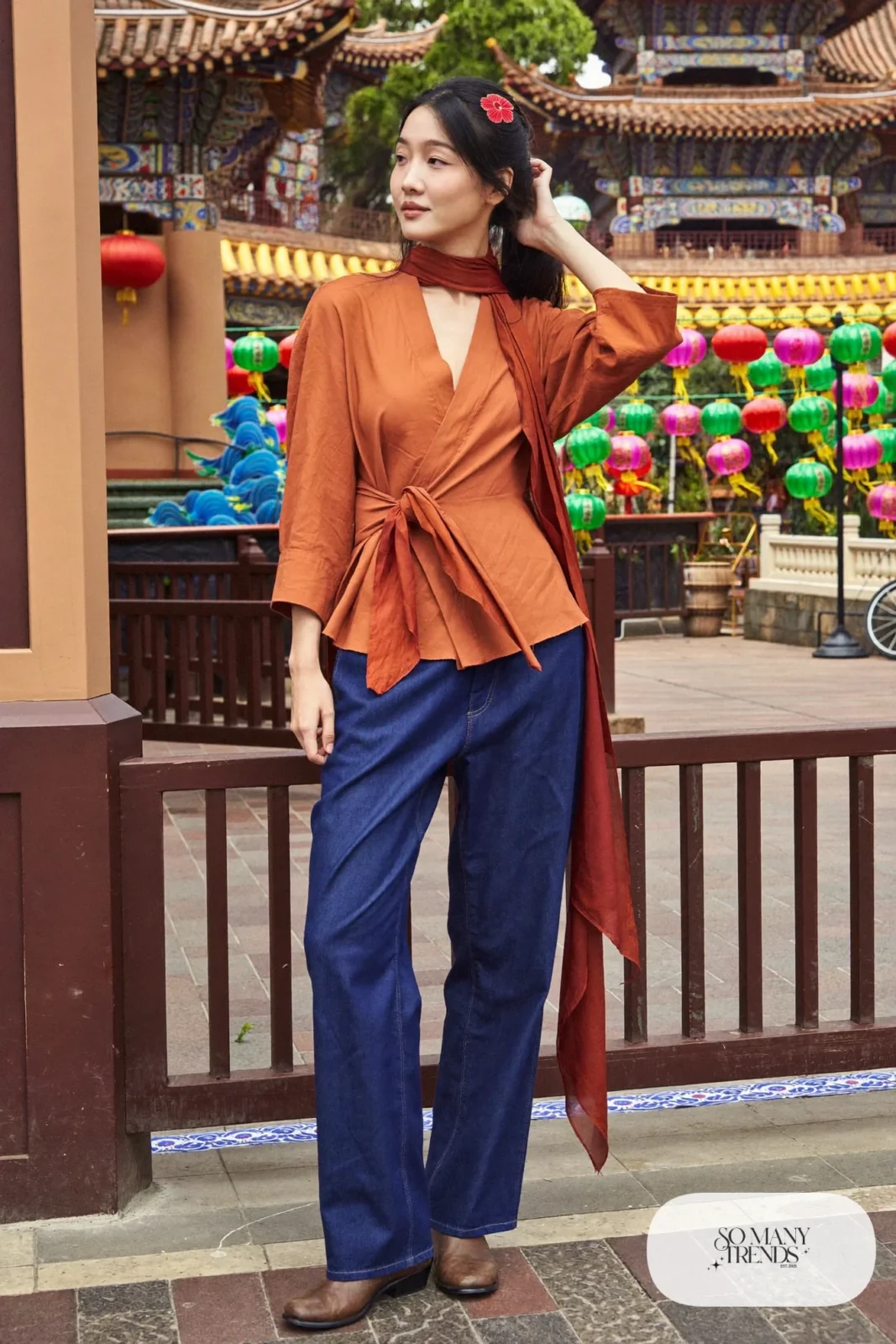 Terracotta wrap top with indigo straight-leg pants, rust silk scarf and flat leather ankle boots, outfit 6