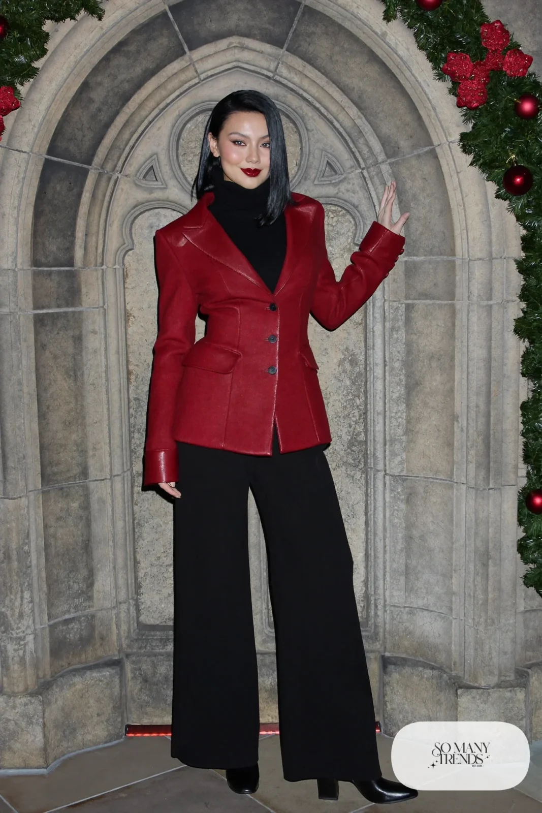 Red velvet jacket over black high-neck sweater with black wide pants and black block-heel boots, outfit 26