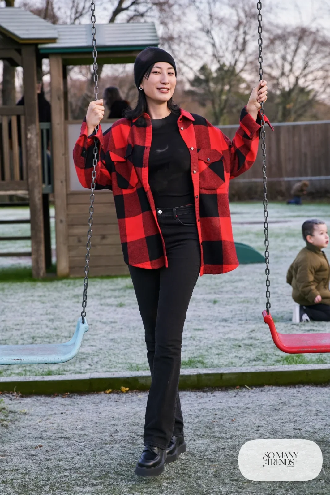Woman in an open red flannel shirt, black fitted tee, black skinny jeans and black platform sneakers, outfit 2