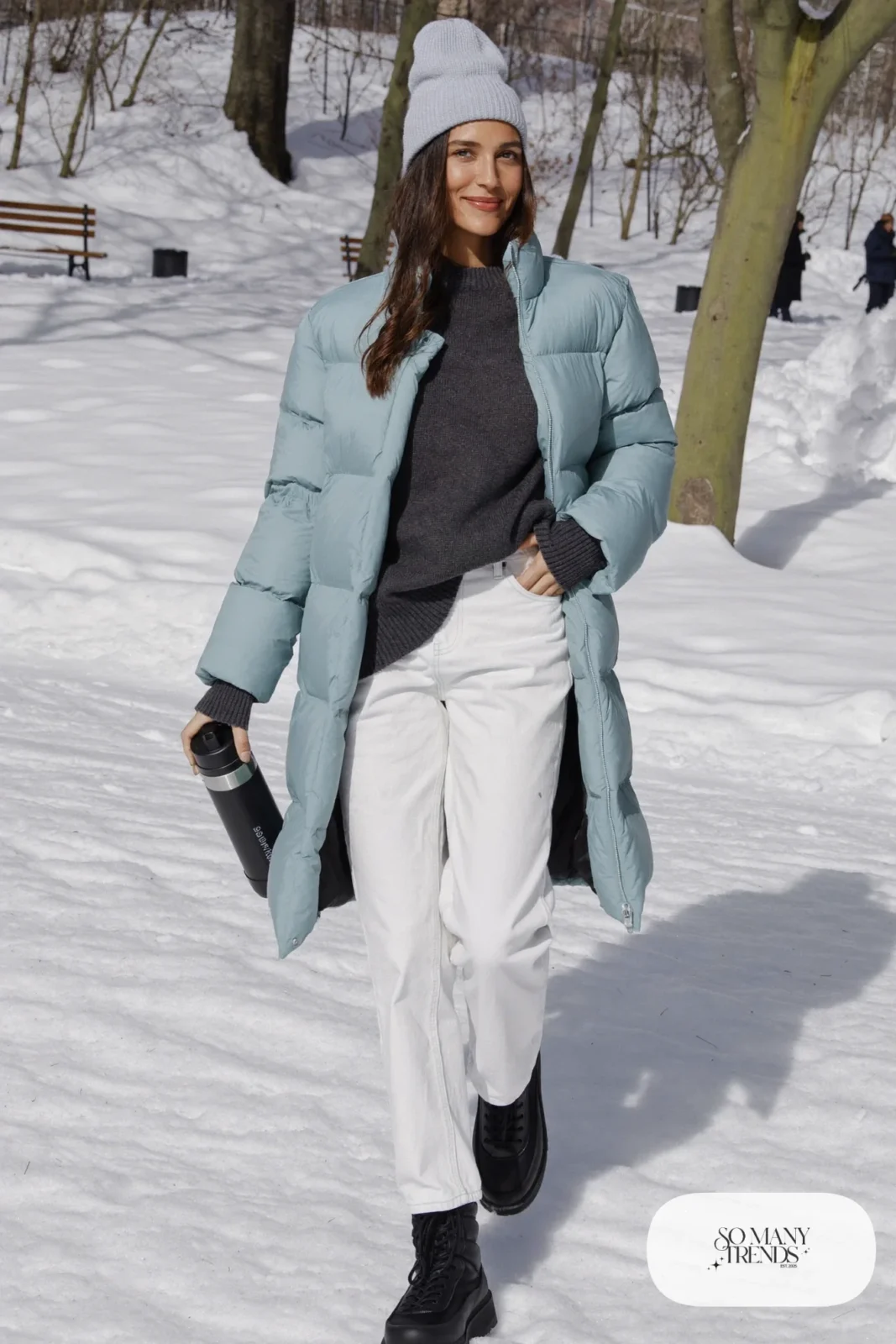 Look 9: long powder blue puffer coat, white straight jeans, charcoal knit sweater and black waterproof boots