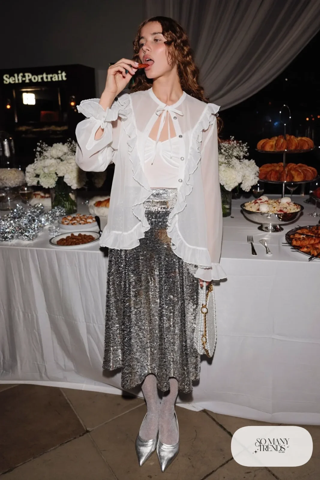 Sheer white chiffon ruffle blouse tucked into silver sequin midi skirt with silver pointed flats, outfit 12
