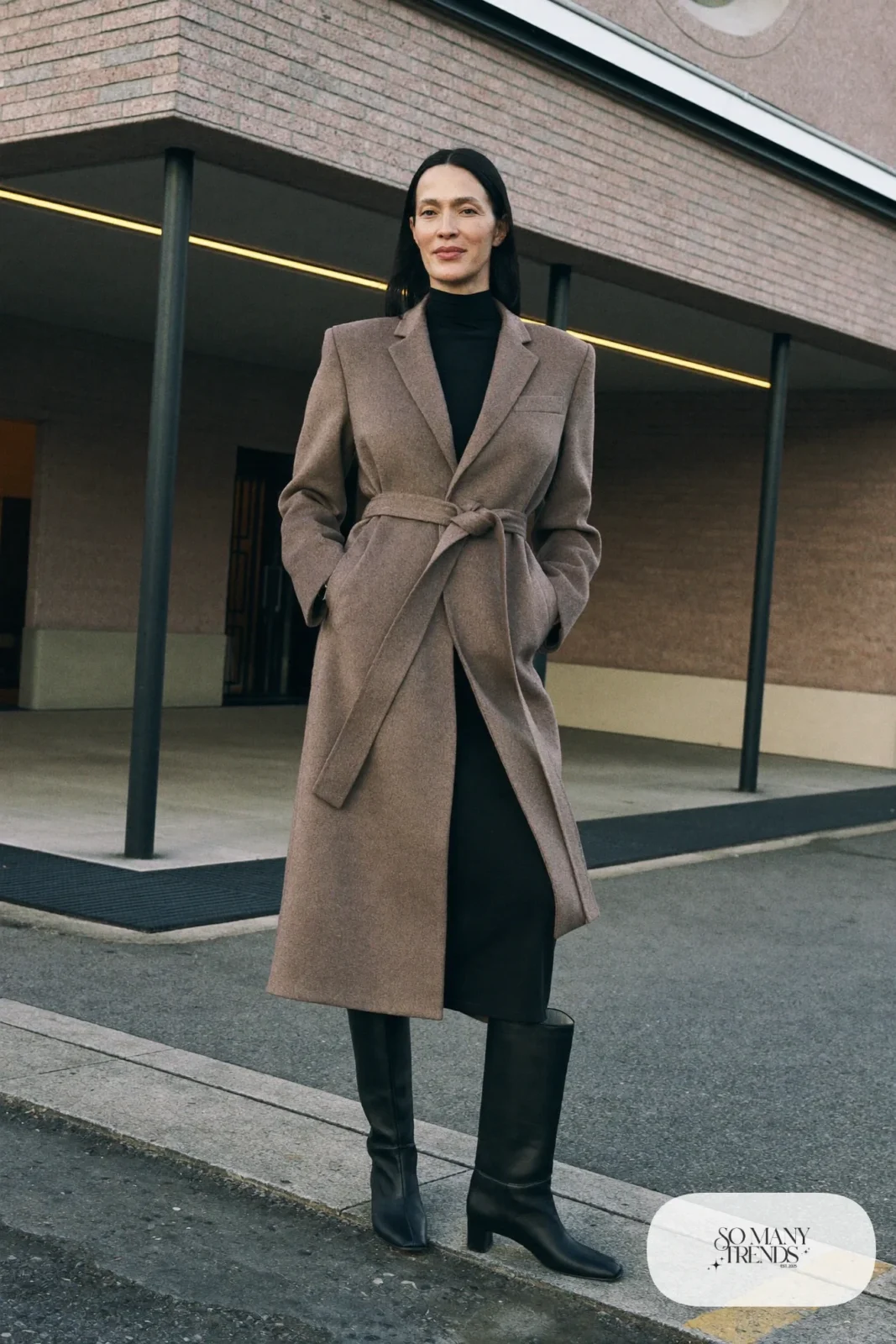 Long taupe wool belted coat over black long-sleeve midi dress with sheer tights and block-heel ankle boots, outfit 3