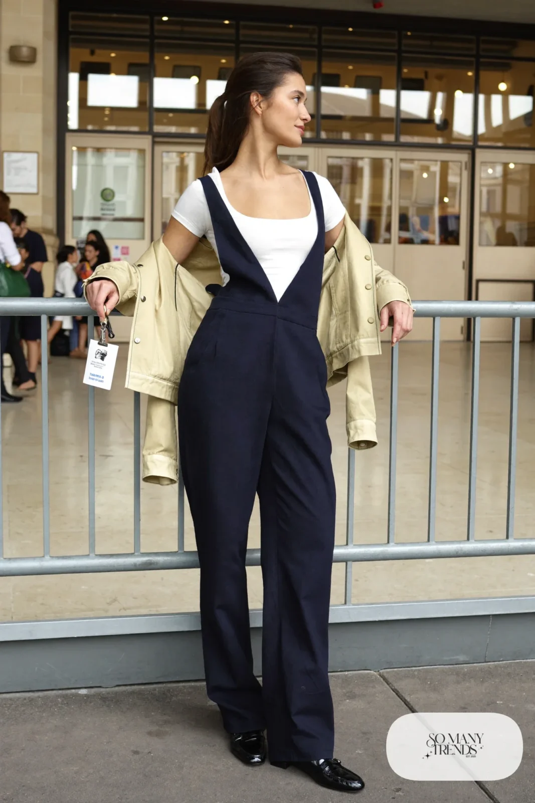 Navy wide-leg jumpsuit over white tee with cropped champagne jacket and loafers, outfit 4