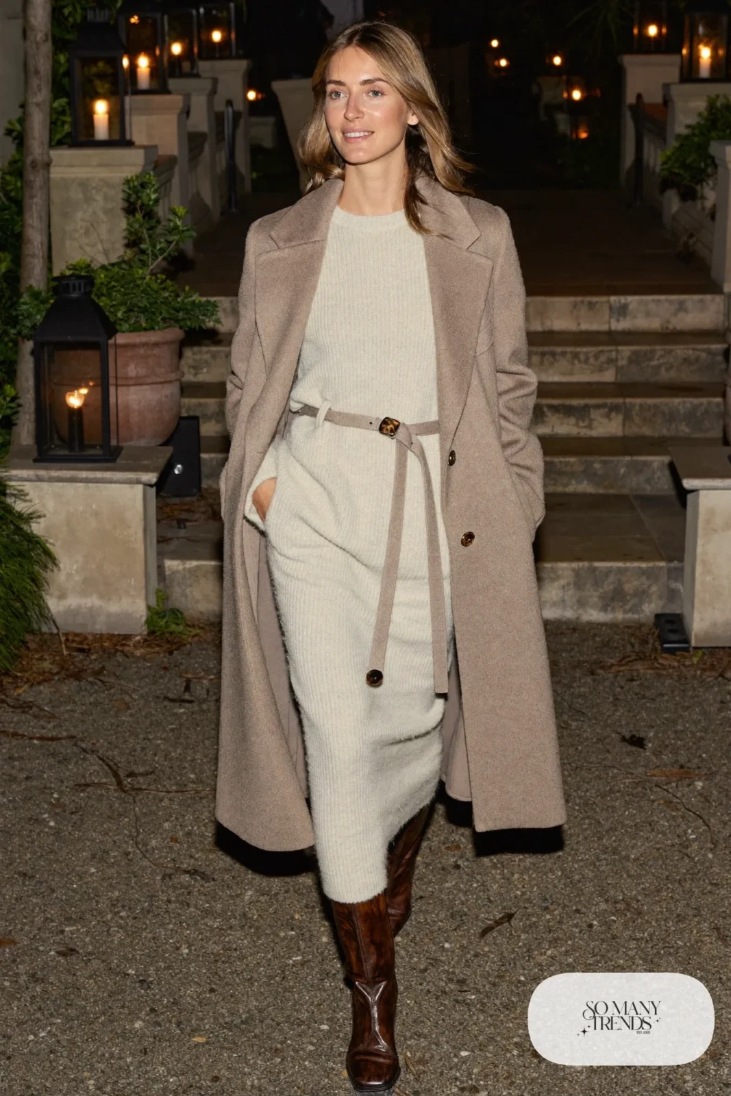 Champagne knit sweater and midi skirt set with belted taupe coat, black tights and tall brown boots, outfit 17