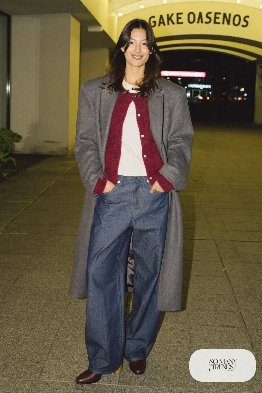 Wide-leg blue jeans, chunky cranberry cardigan over cream tee, long gray coat and brown leather boots, outfit 19