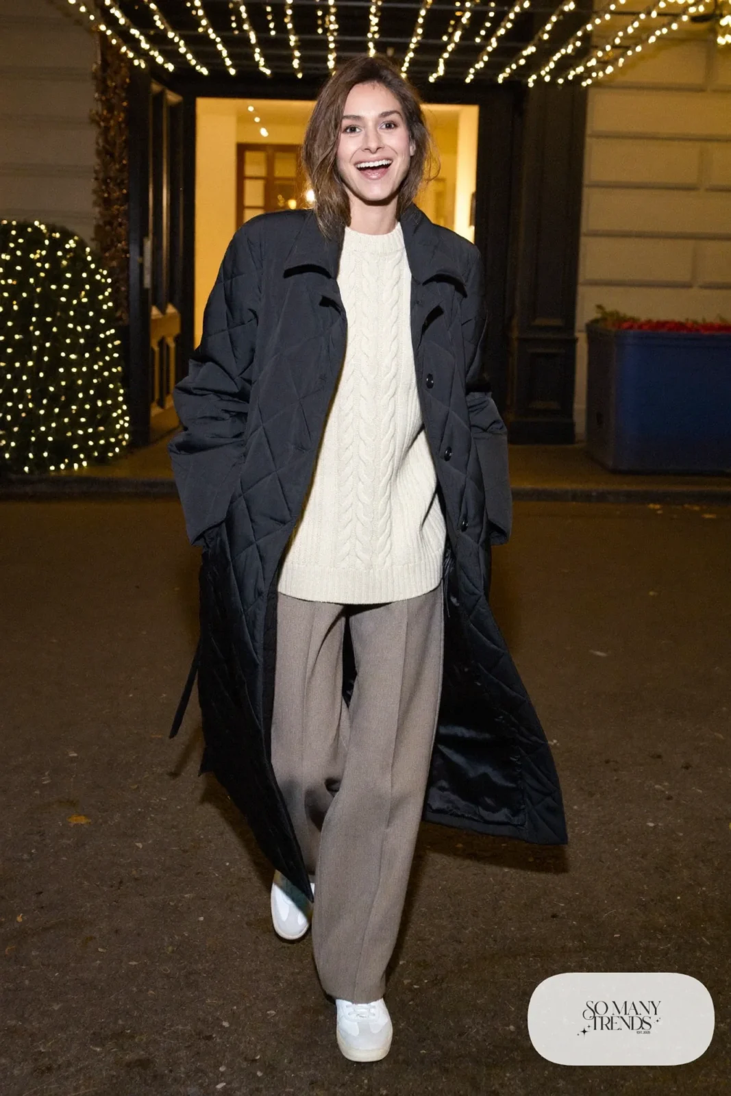 Taupe wide-leg pants with cream Aran sweater, black quilted coat and white leather sneakers, outfit 21