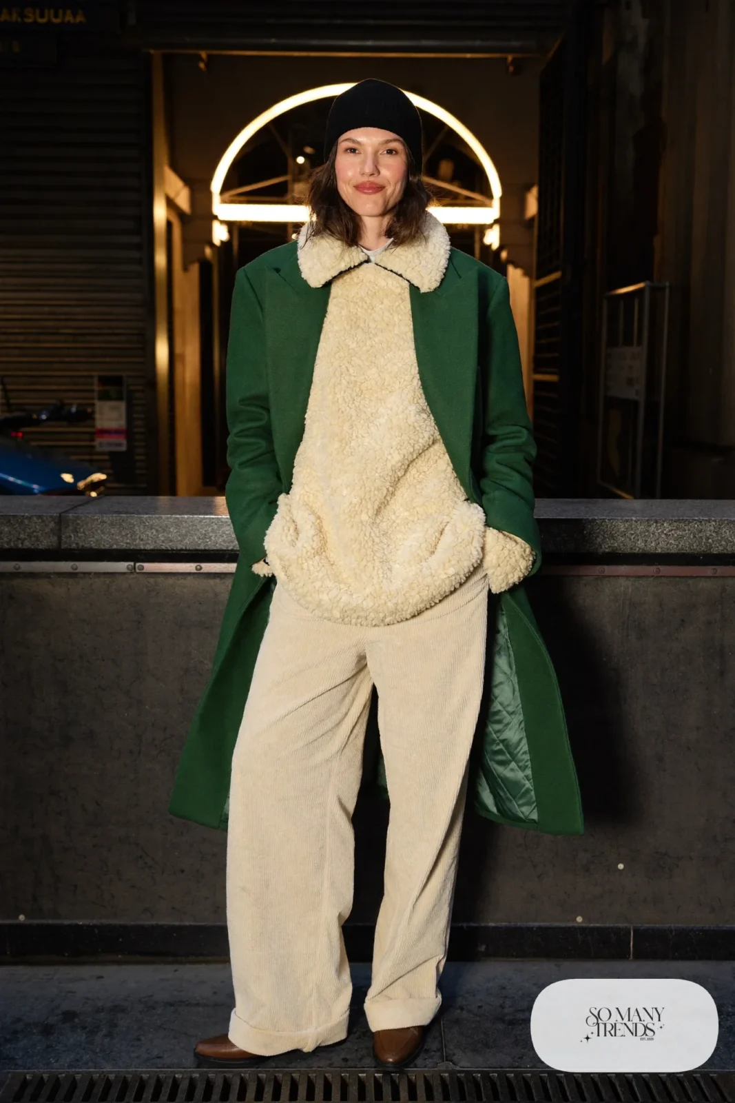 Cream corduroy pants with chunky pullover, forest green long coat and brown boots, outfit 24