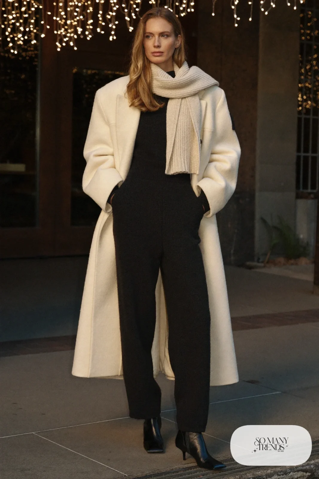 Black knit wide-leg jumpsuit with cream chunky wool coat, black ankle boots and champagne scarf, outfit 29