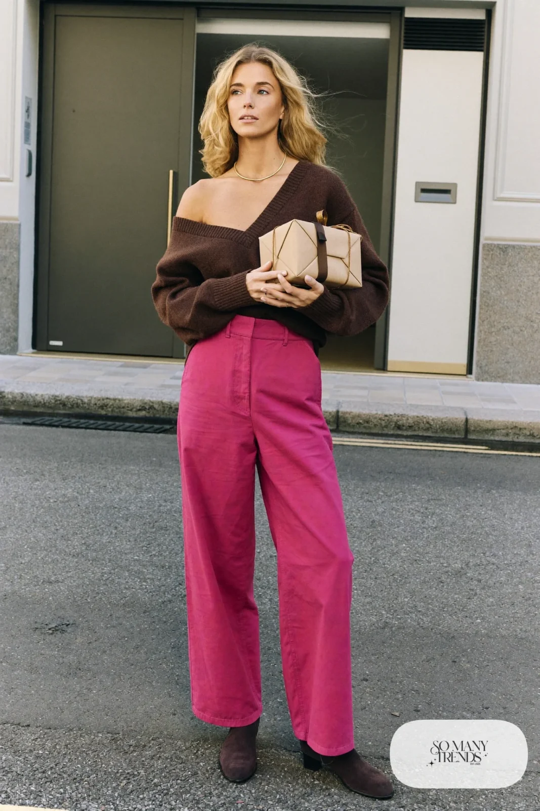Woman in a chocolate brown V-neck sweater, dusty pink wide-leg pants, brown suede boots and gold necklace, outfit 21