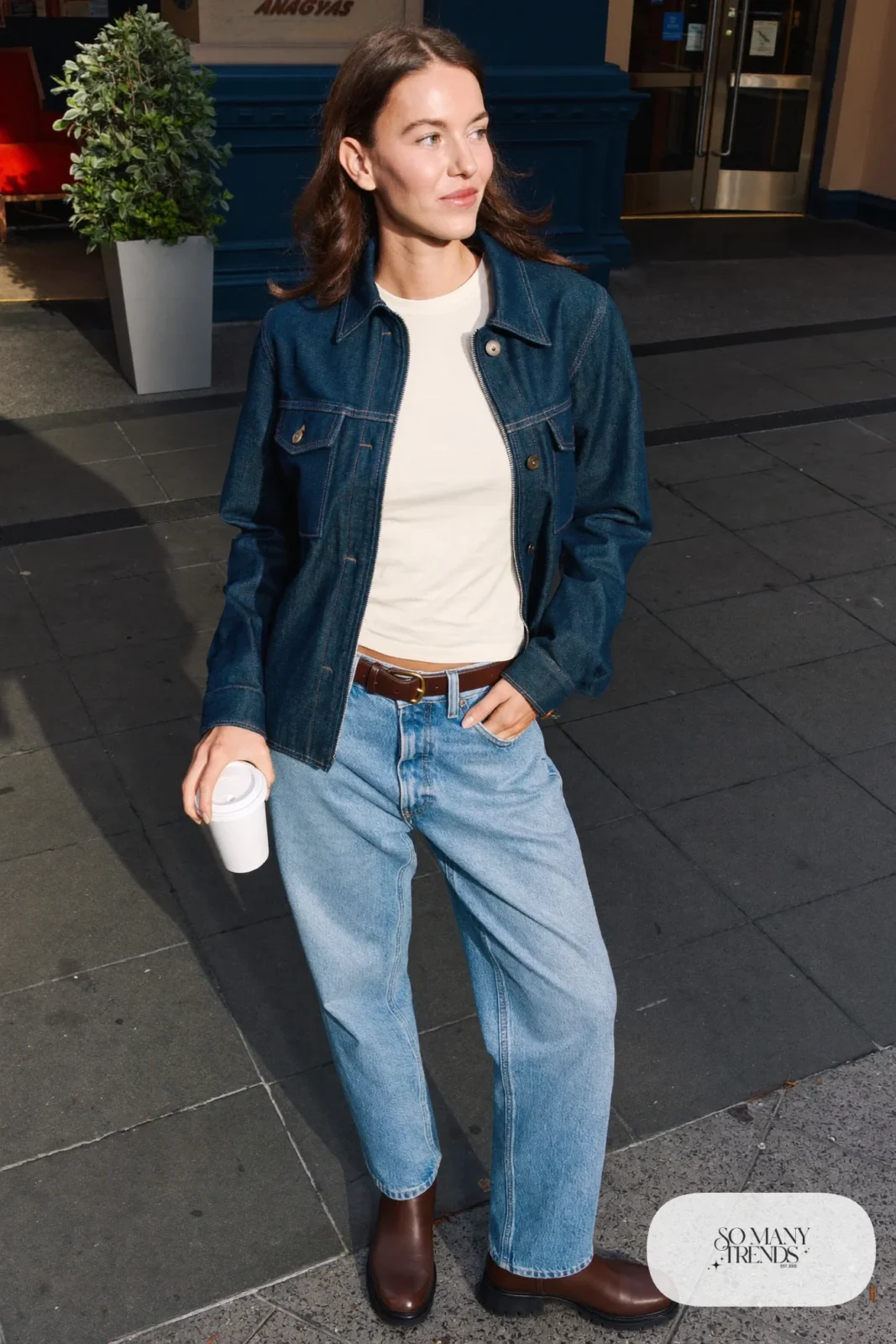 Woman in a boxy dark indigo denim jacket, cream tee, straight jeans and brown leather boots in Las Vegas, outfit 2