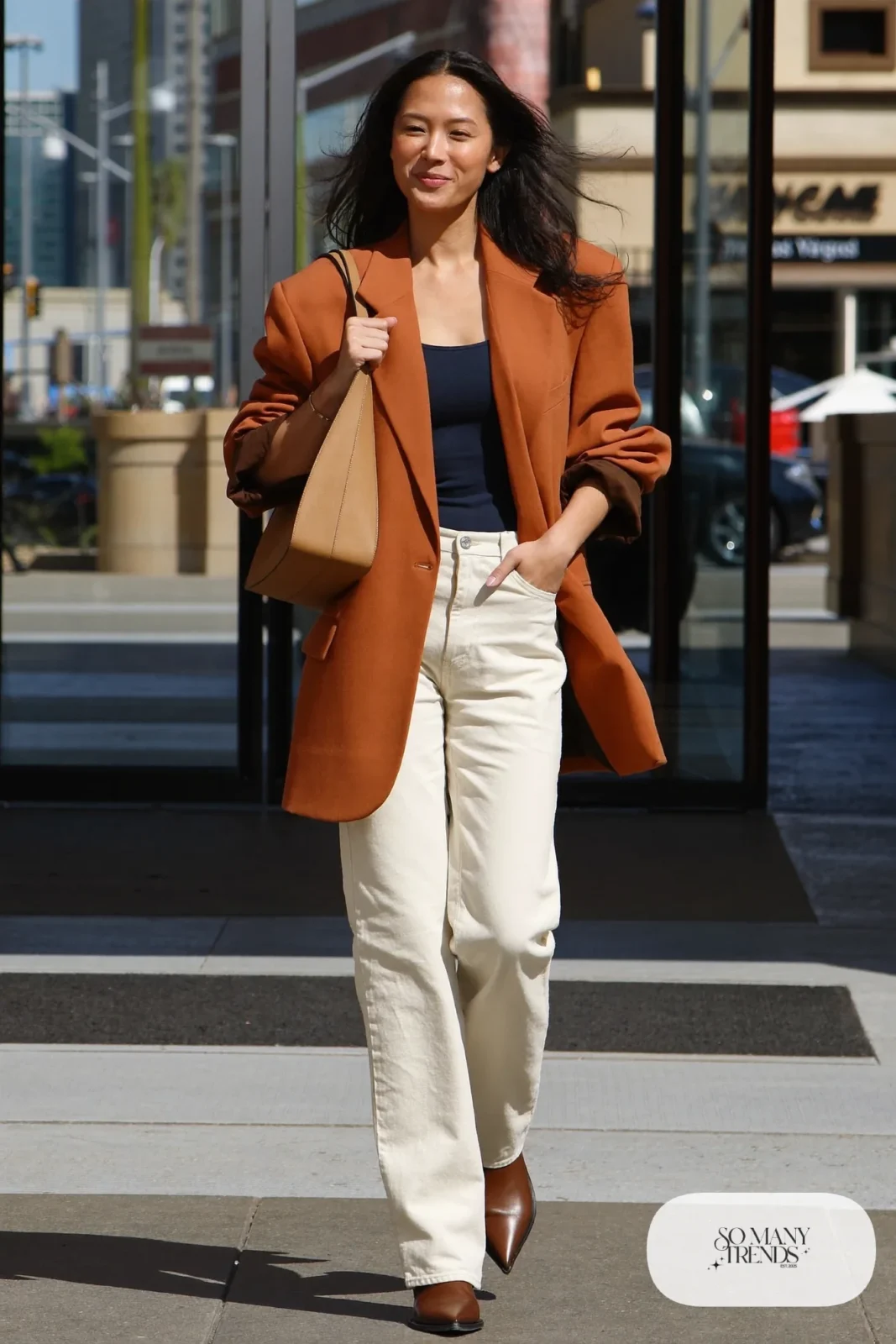 Woman in an oversized terracotta blazer, black tee, cream jeans and ankle boots in Las Vegas, outfit 26