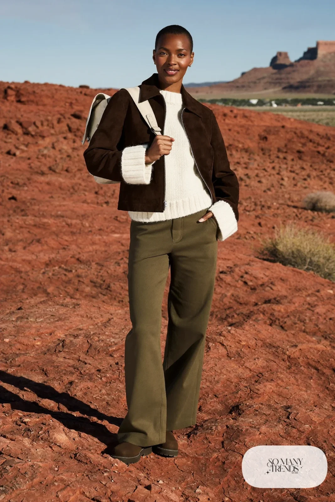 Woman in olive wide-leg pants, cream knit, chocolate suede jacket and lug-sole boots for a desert day trip near Las Vegas, outfit 27