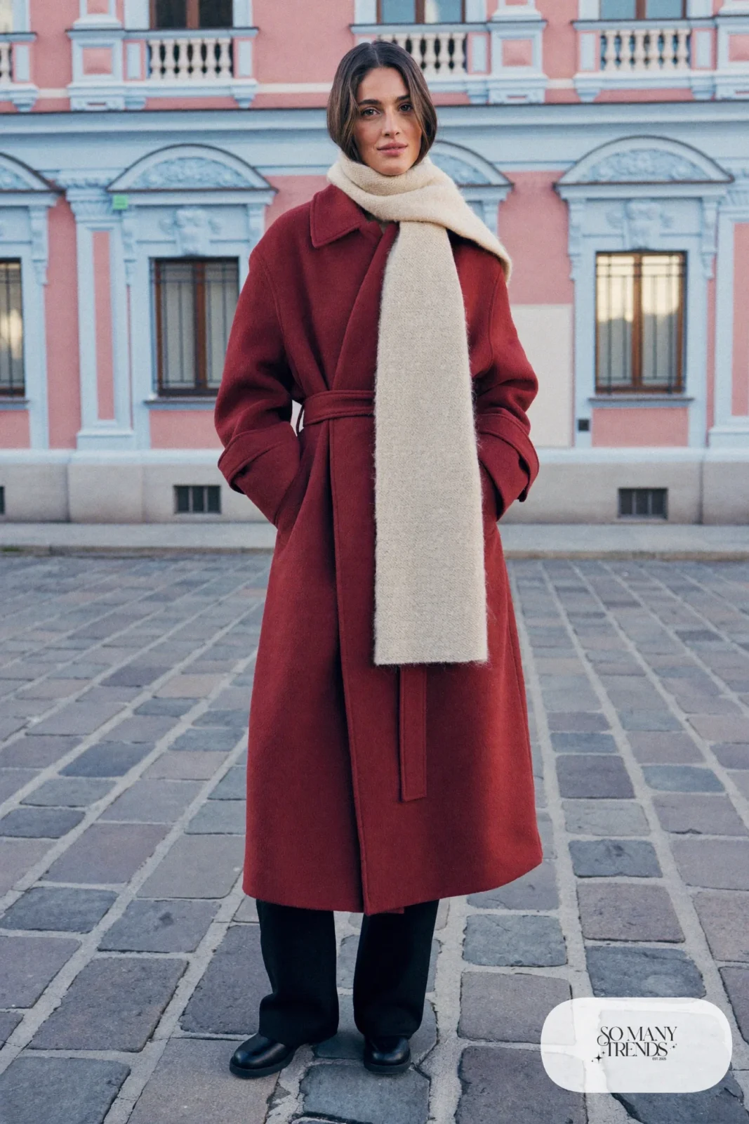 Burgundy belted wrap coat, cream wool scarf, black pants and tall flat boots, Prague winter outfit 3