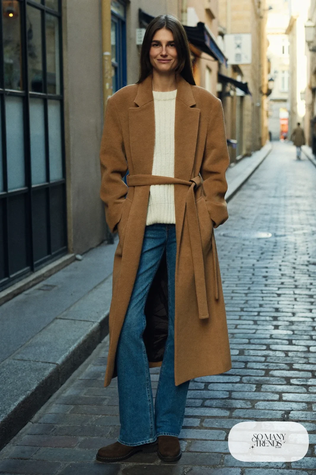 Camel wool wrap coat, cream knit sweater, straight blue jeans and chunky ankle boots, Prague winter outfit 5