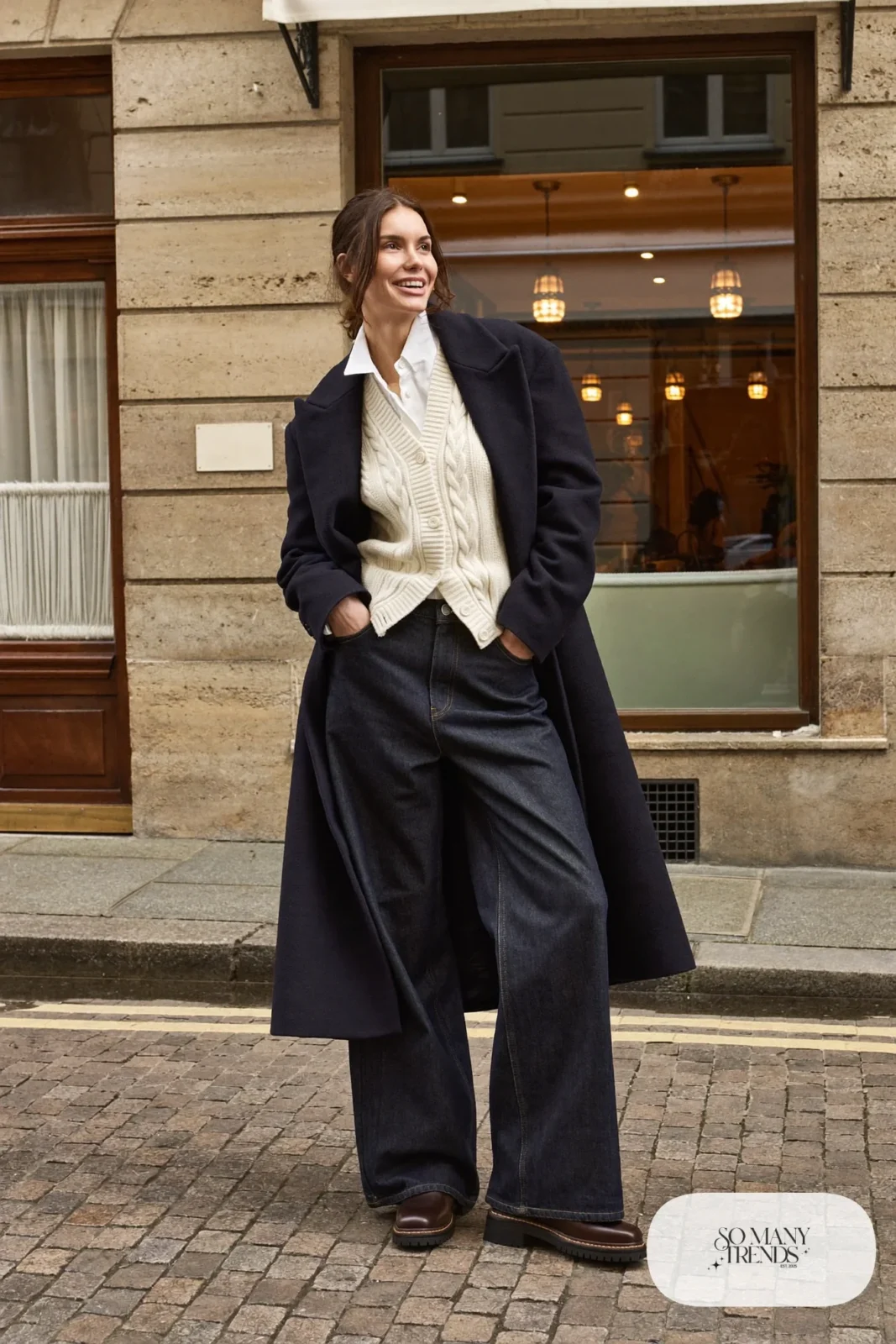 Cream cable knit cardigan, white shirt, wide dark jeans, navy wool coat and brown boots, Prague winter outfit 8