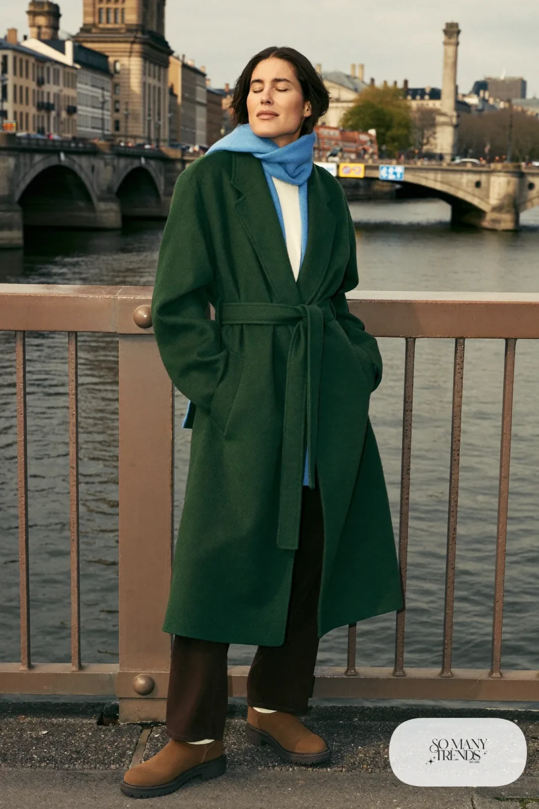 Forest green wool coat, sky blue scarf, cream sweater, dark pants and brown grippy boots, Prague winter outfit 17