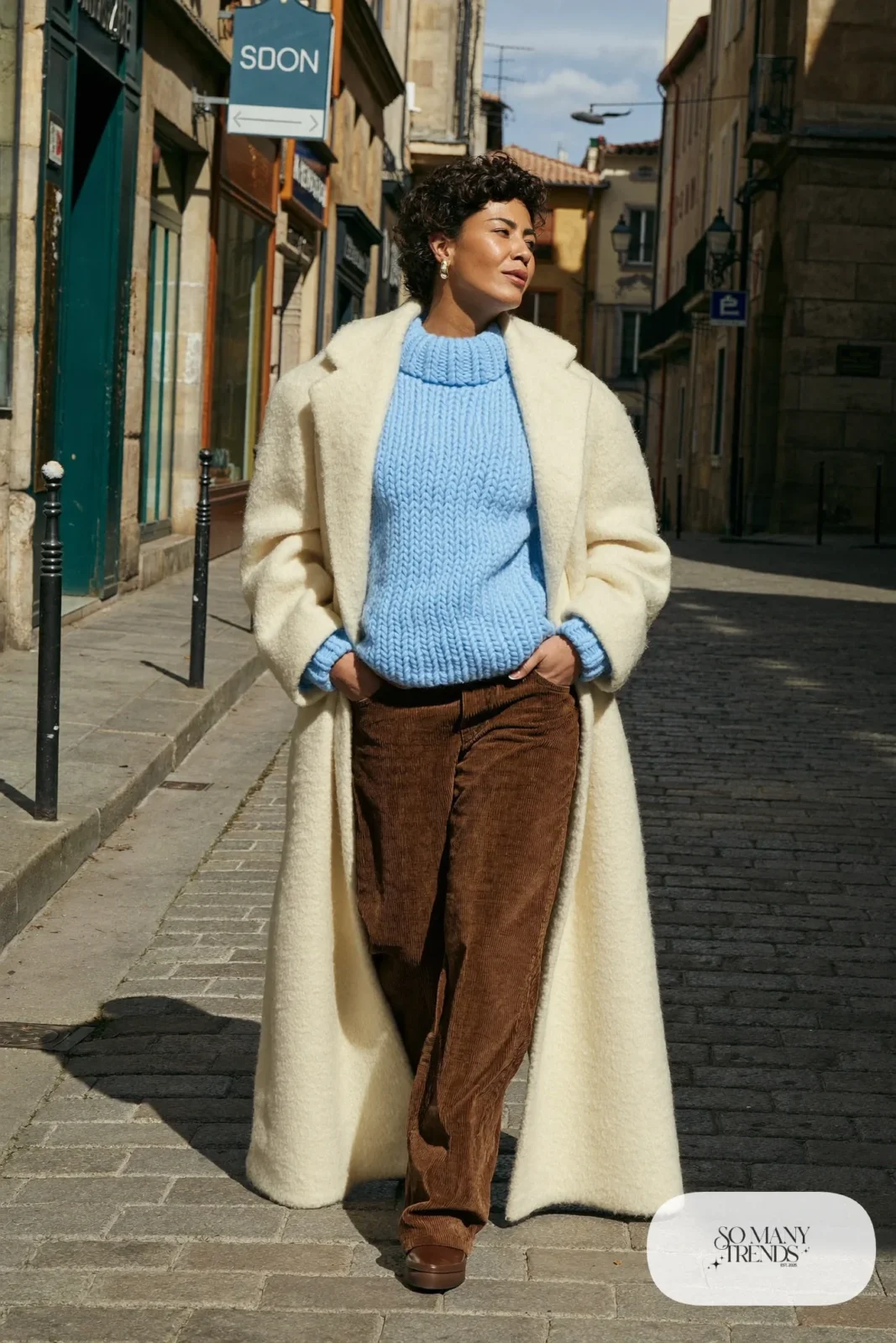 Sky blue knit sweater, mocha corduroy pants, long cream wool coat and rubber-sole ankle boots, Prague winter outfit 20