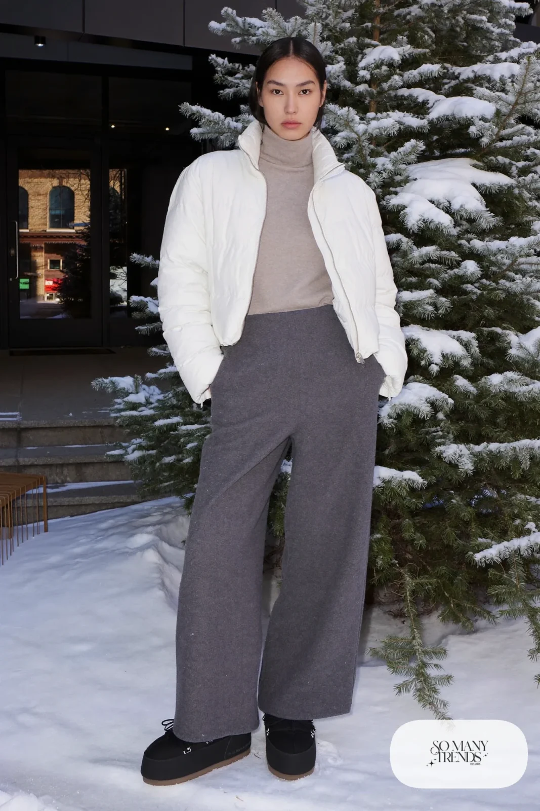 White cropped down jacket with high-waisted gray wool pants and snow boots, outfit 9