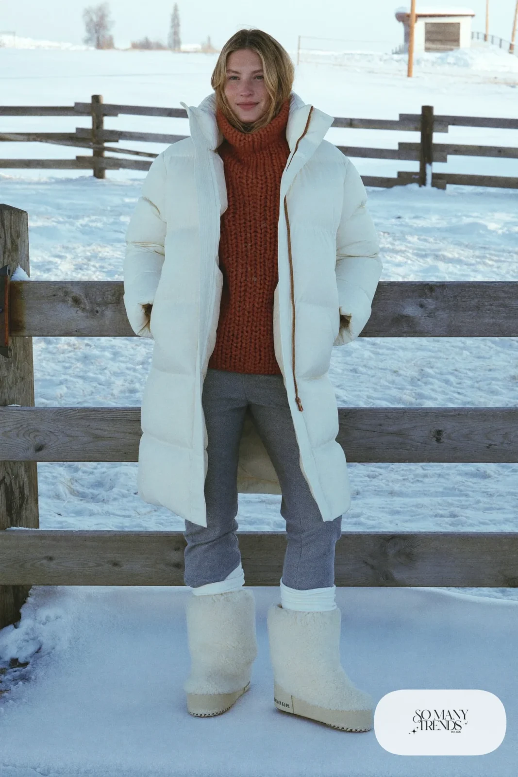 Rust chunky knit sweater with cream puffer jacket, gray pants and cream snow boots, outfit 13