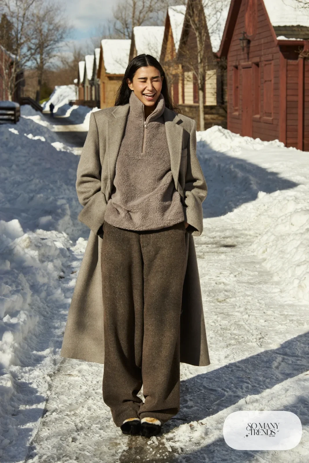 Dove gray fleece half-zip with brown wool pants and long beige coat on a snowy walk, outfit 17