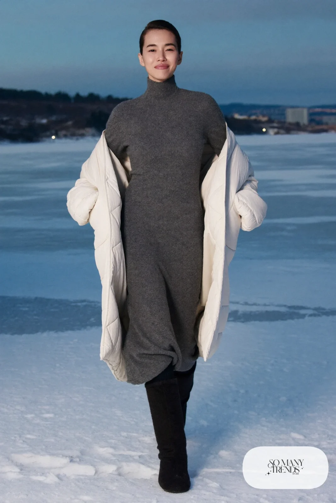 Dove gray wool maxi dress with sheepskin boots and long white coat on a frozen lake, outfit 27