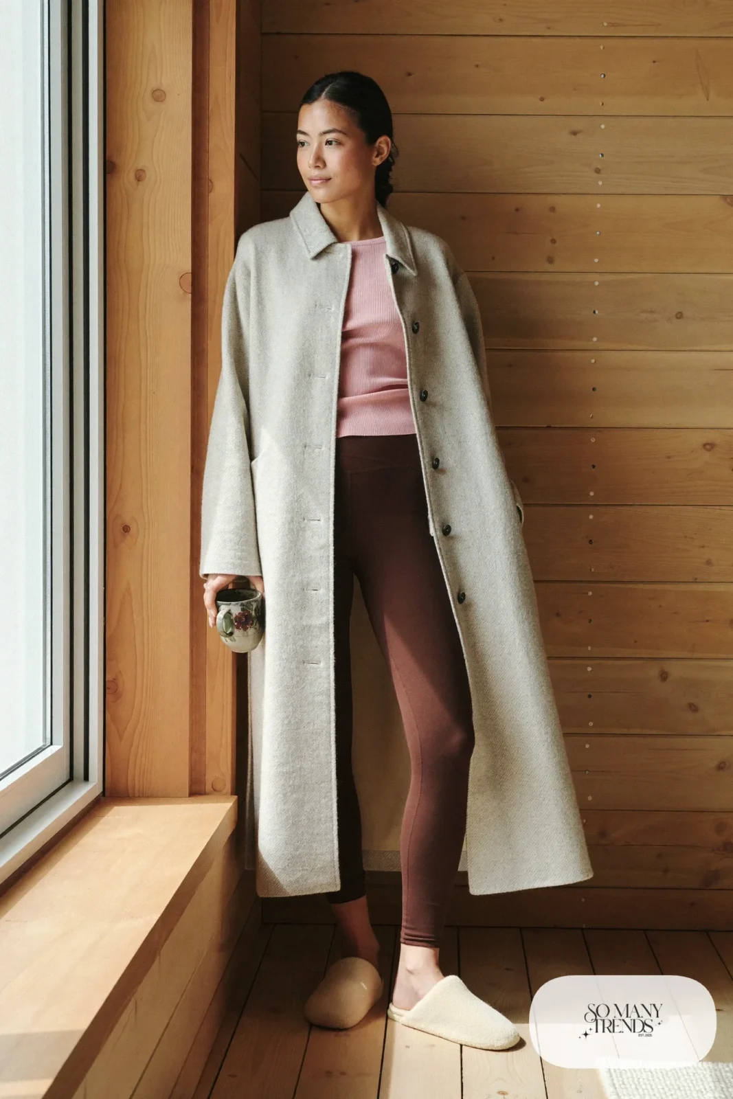 Look 13: long cream cardigan coat over a rose knit top and chocolate leggings with cream slippers, cabin window nook