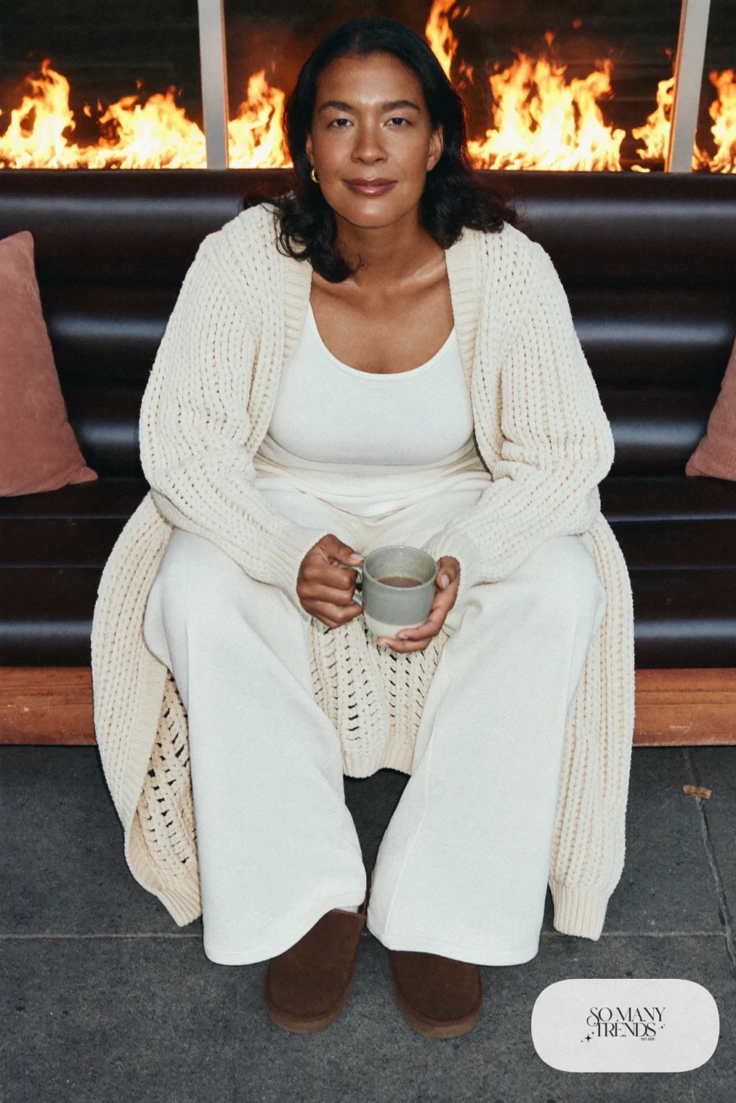 Look 15: cream knit cardigan and wide knit pants set with chocolate slippers, cabin couch with blanket