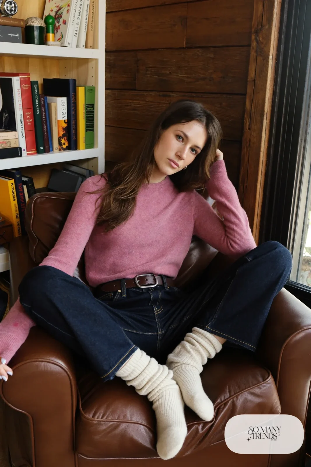 Look 17: rose wool blend sweater tucked into dark straight jeans with a chocolate belt and cream socks, cabin reading corner