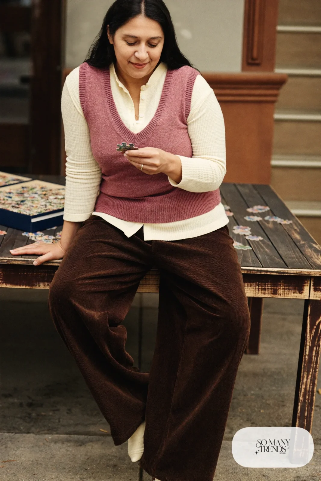 Look 18: cream waffle henley with a rose knit vest and chocolate corduroy pants with socks, cabin kitchen table