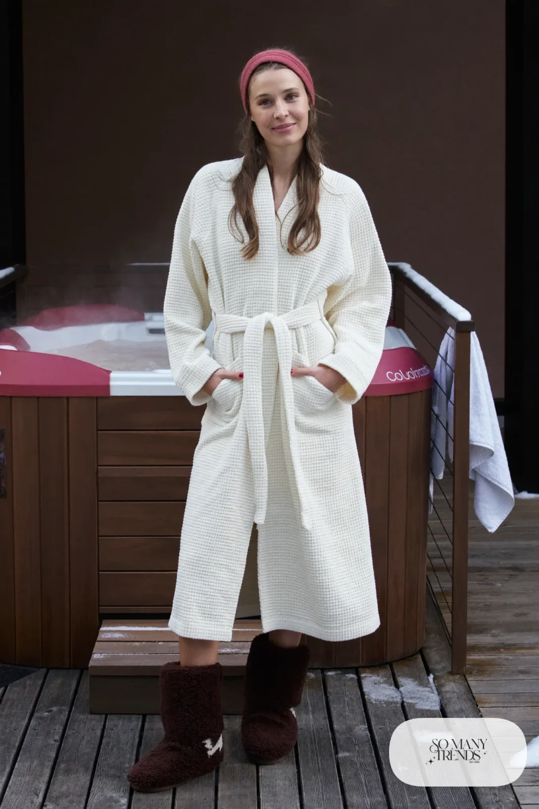 Look 19: long cream terry robe with chocolate shearling boots, snowy deck beside a steaming hot tub