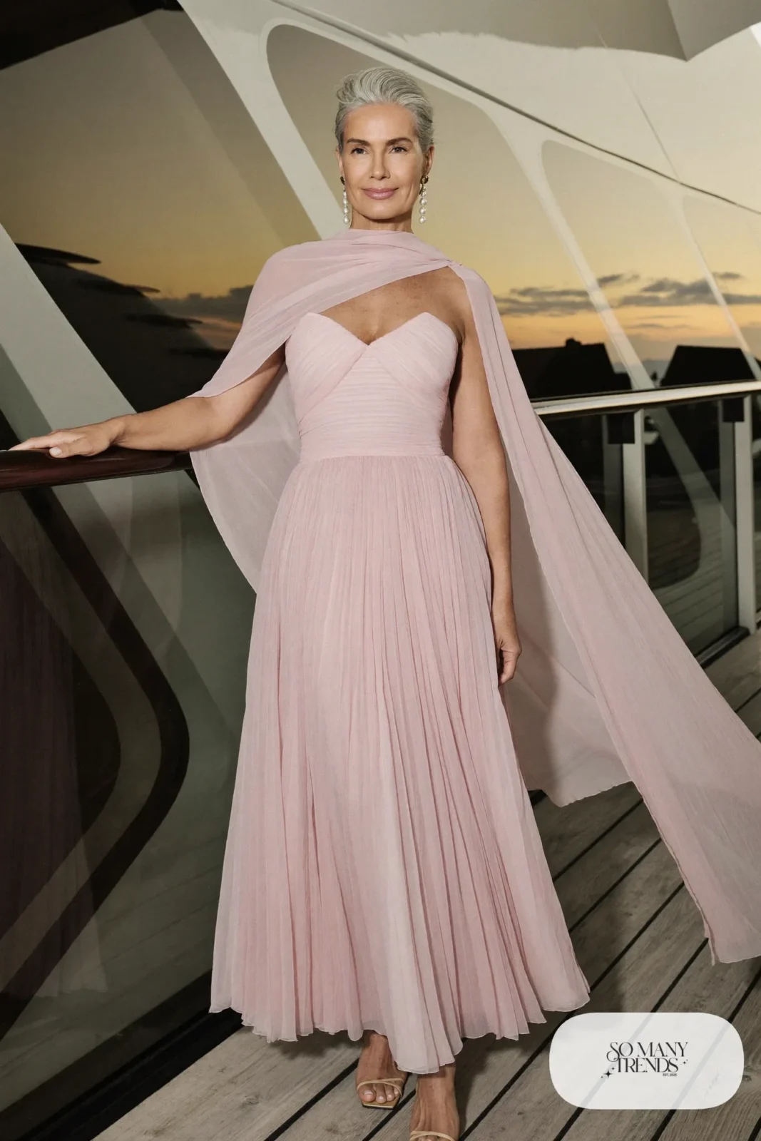 Blush pleated chiffon gown with cape back and nude sandals with pearl earrings, formal night cruise look 9