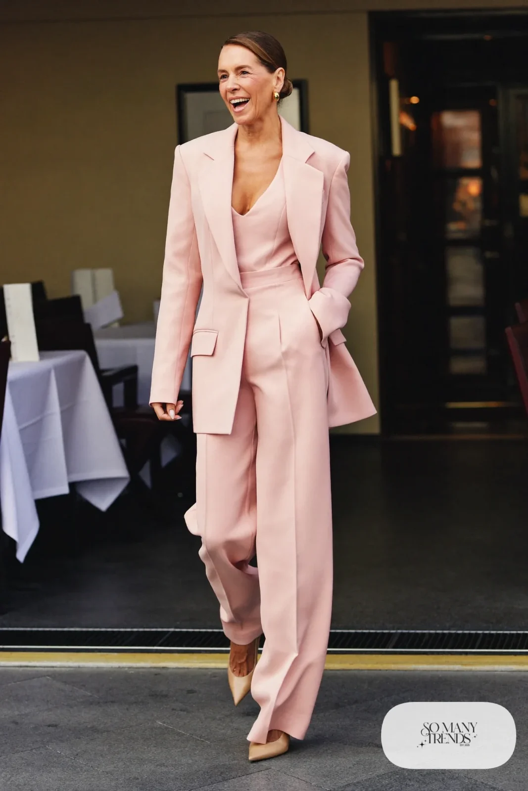Blush pink tuxedo-style wide-leg jumpsuit with gold belt and nude pumps, formal night cruise look 23