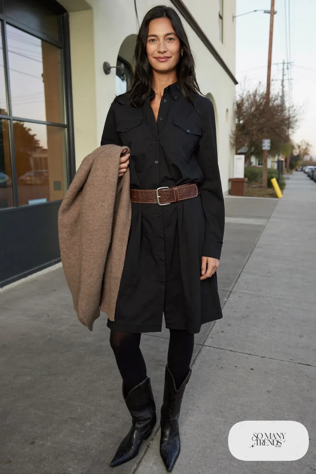 Woman in a black western shirt dress with wide brown belt, black tights and brown boots, outfit 9