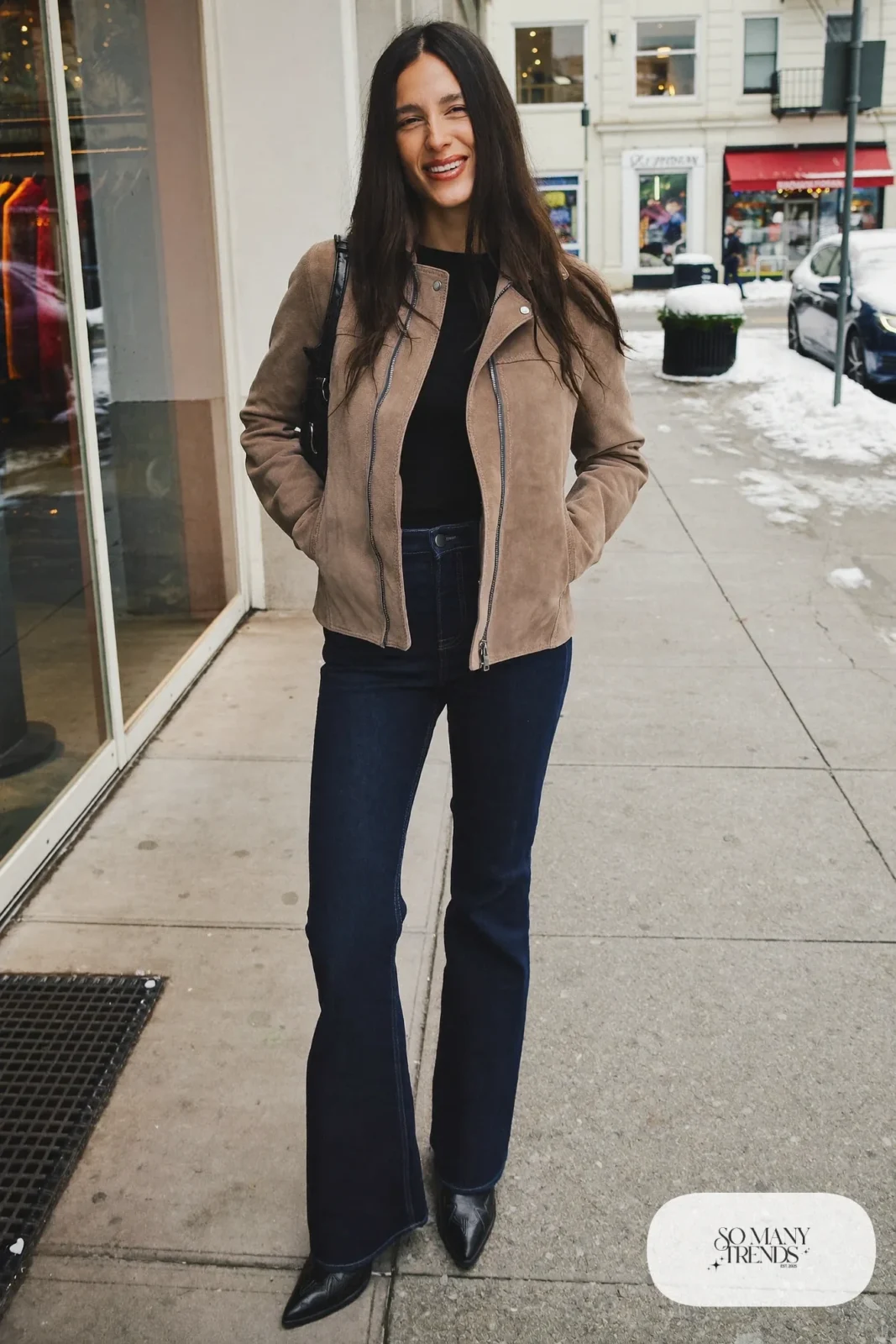 Woman in dark flared jeans, a suede jacket and black cowboy boots, outfit 16