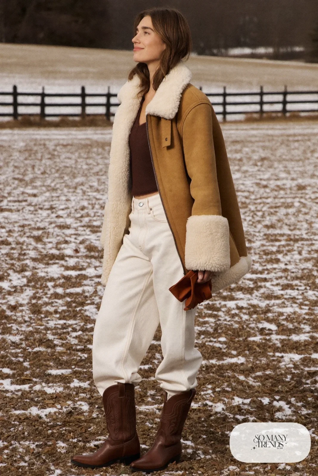 Woman in white jeans, a tan shearling jacket and brown cowboy boots, outfit 17