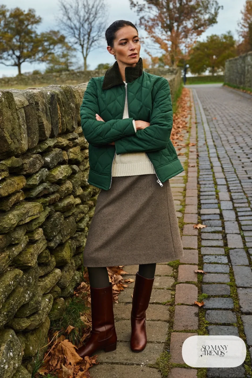 Woman in a green quilted jacket, wool skirt, tights and brown boots, outfit 21
