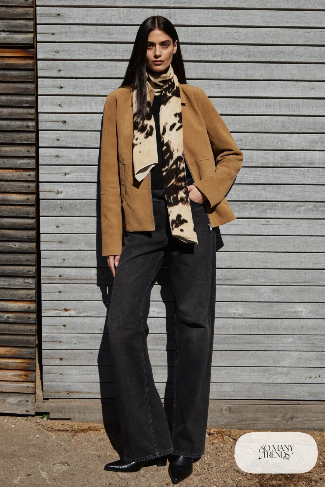 Woman in an all-black outfit with a cowhide print scarf and tan suede jacket, outfit 22