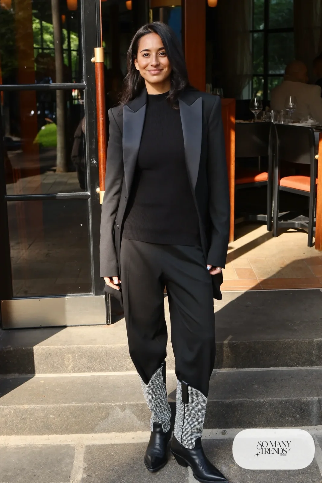 Woman in black blazer, black fitted knit, black straight pants and rhinestone-studded black cowboy boots, outfit 12