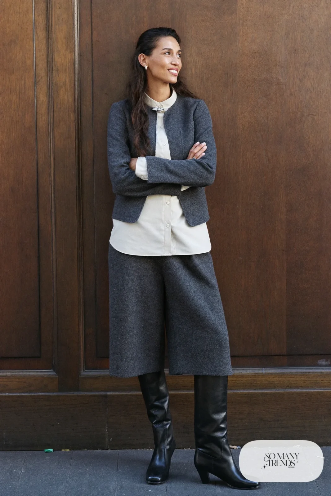Woman in charcoal wool culottes with fitted jacket and ivory blouse with tall boots, western gala outfit 24