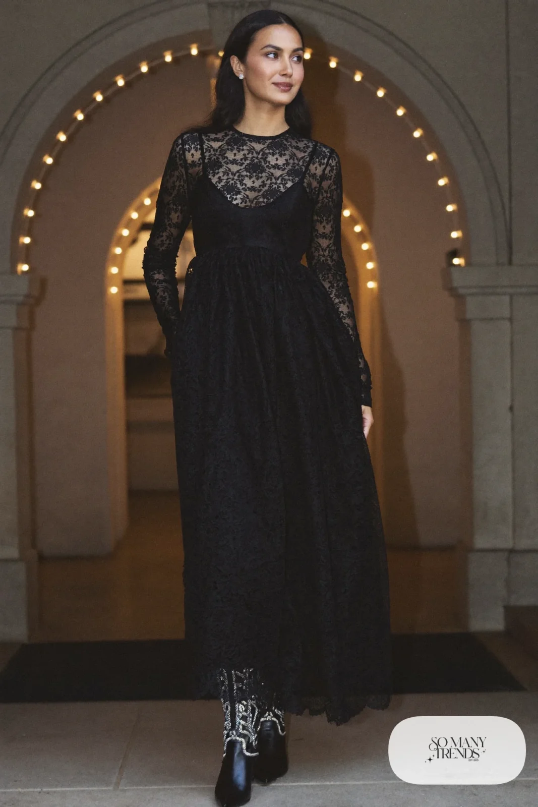 Woman in a black lace gown with sheer sleeves and dressy black cowboy boots, western gala outfit 25