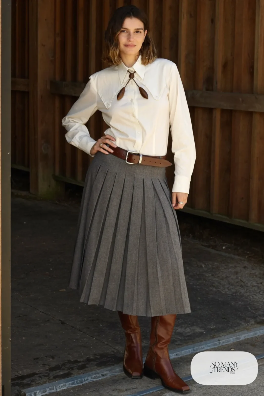 Gray pleated midi skirt with ivory western blouse, bolo tie and tall brown boots, outfit 19