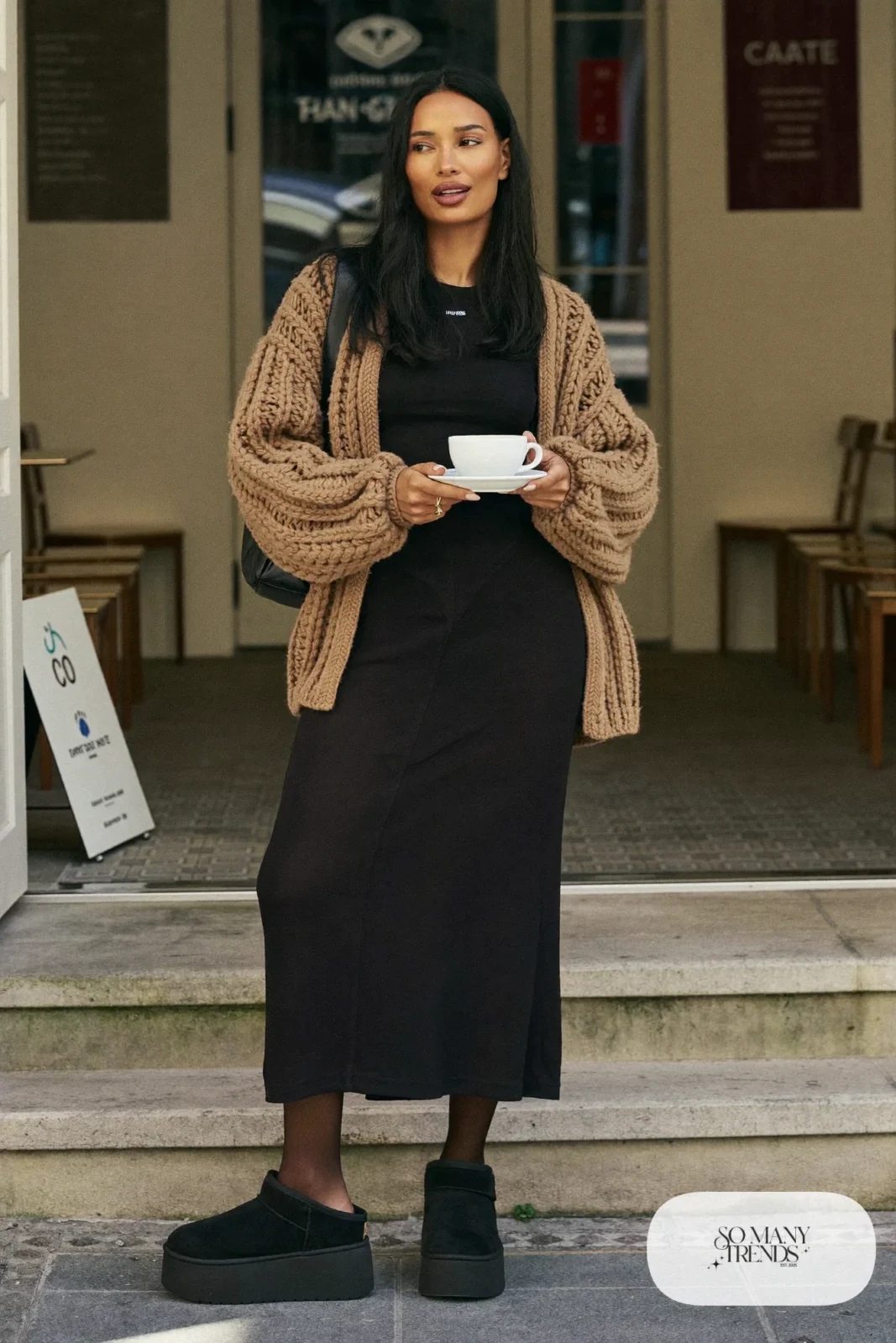 Oatmeal chunky cardigan, long black skirt, sheer black tights and black Ugg clogs, outfit 3