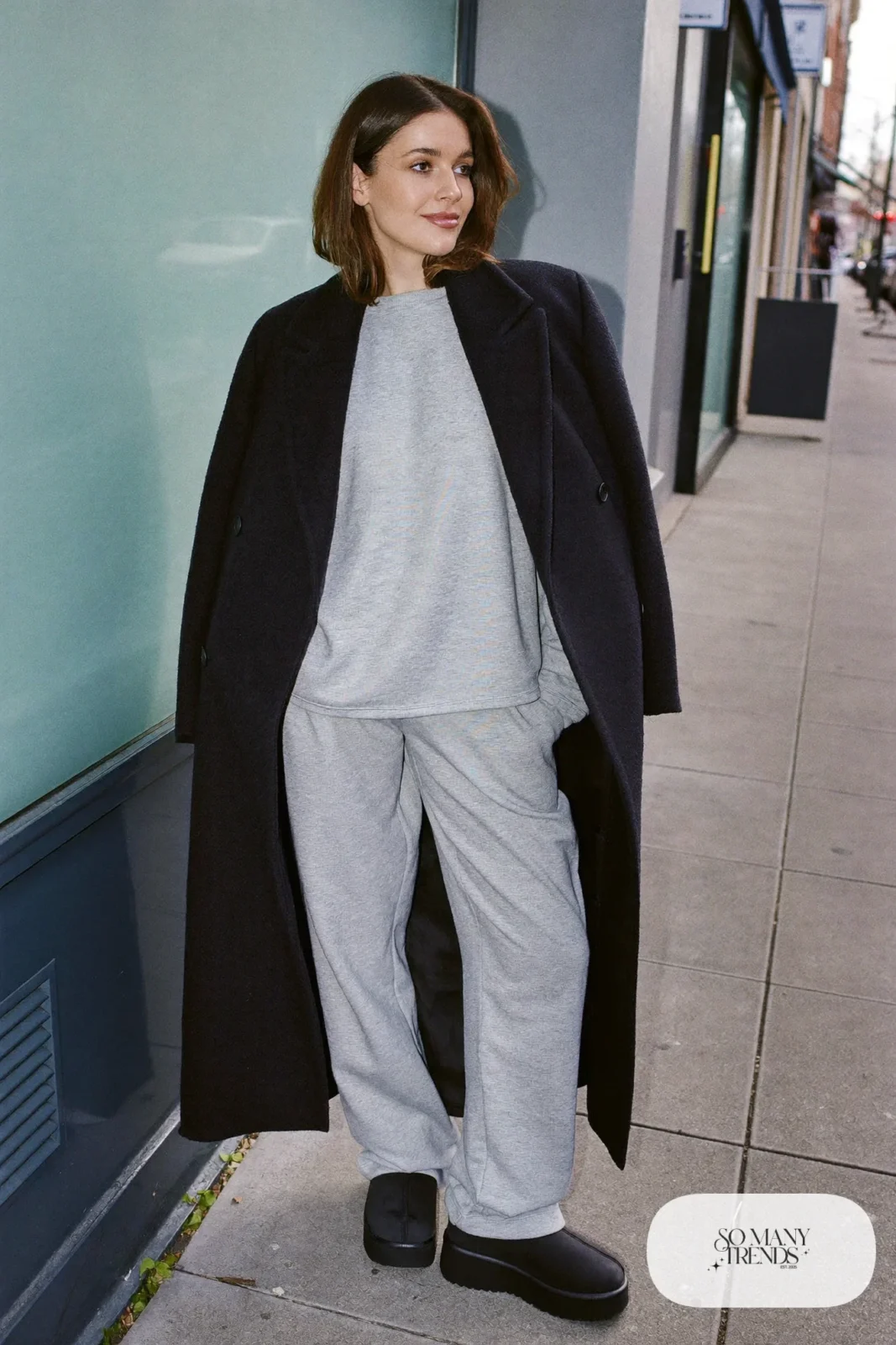 Gray sweatshirt, gray straight sweatpants, long black wool coat and black Ugg clogs, outfit 15