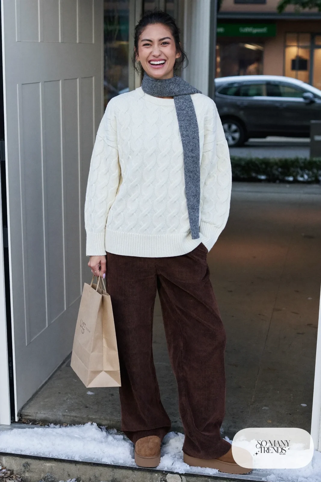 Cream Aran cable-knit sweater, chocolate brown corduroy pants and chestnut Ugg clogs, outfit 19