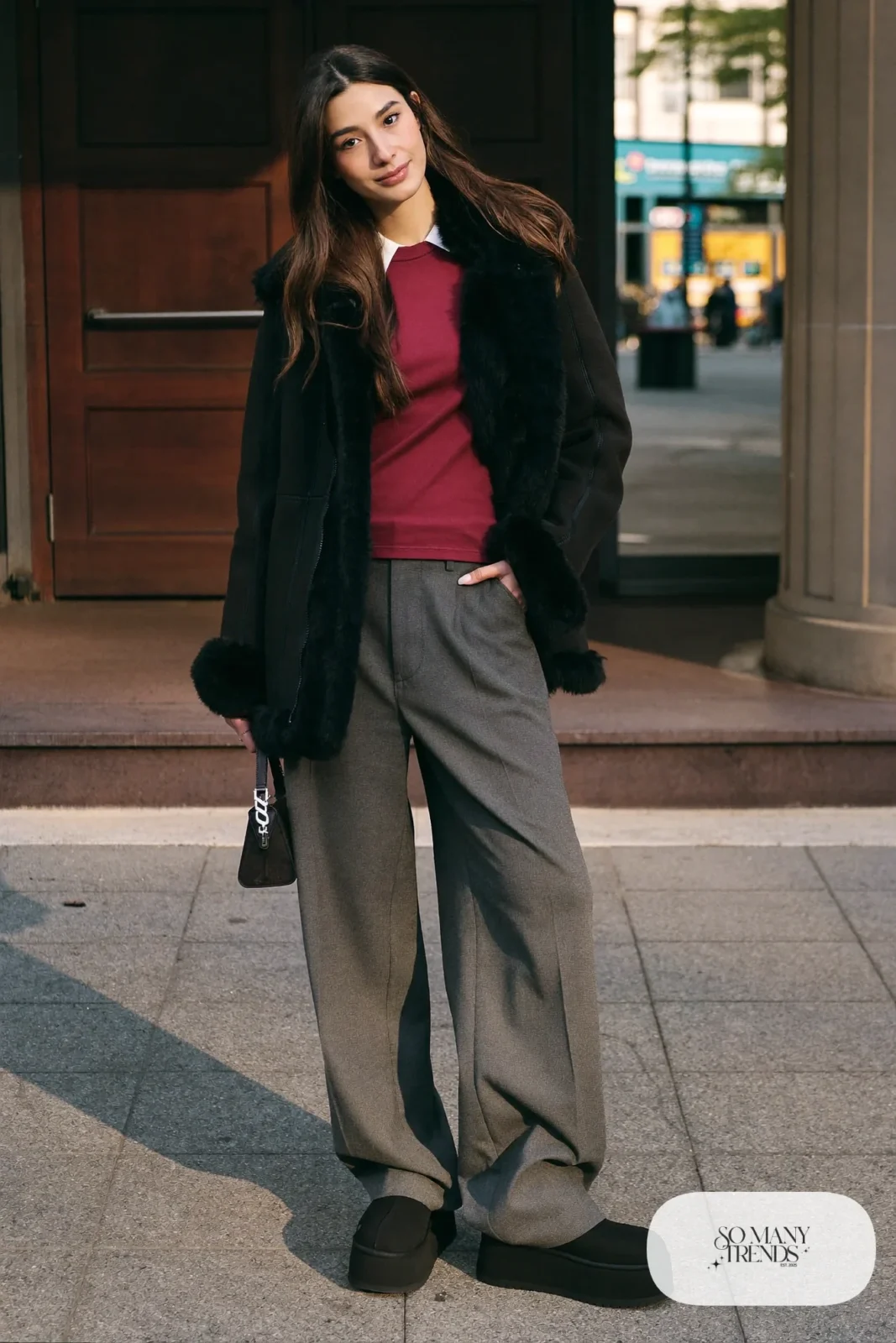 Black shearling jacket, wine tee, gray wide-leg pants and black Ugg clogs, outfit 24