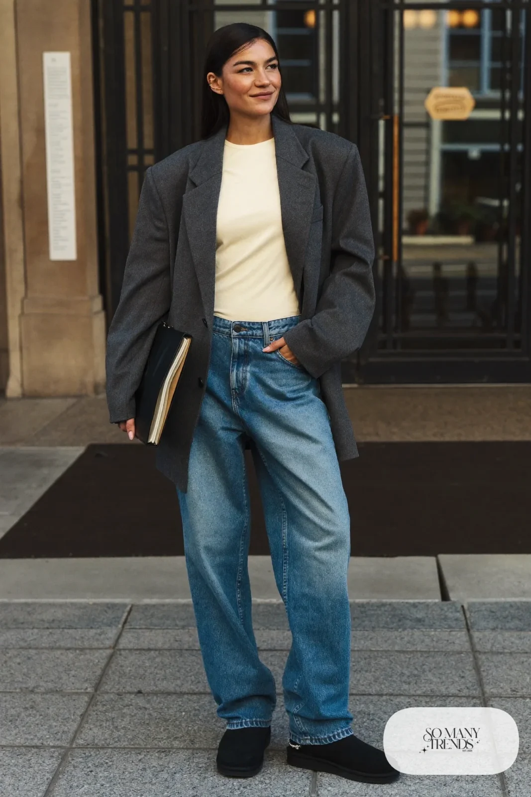 Woman in straight blue jeans, cream tee, charcoal oversized blazer and black Ugg mini boots, outfit 4
