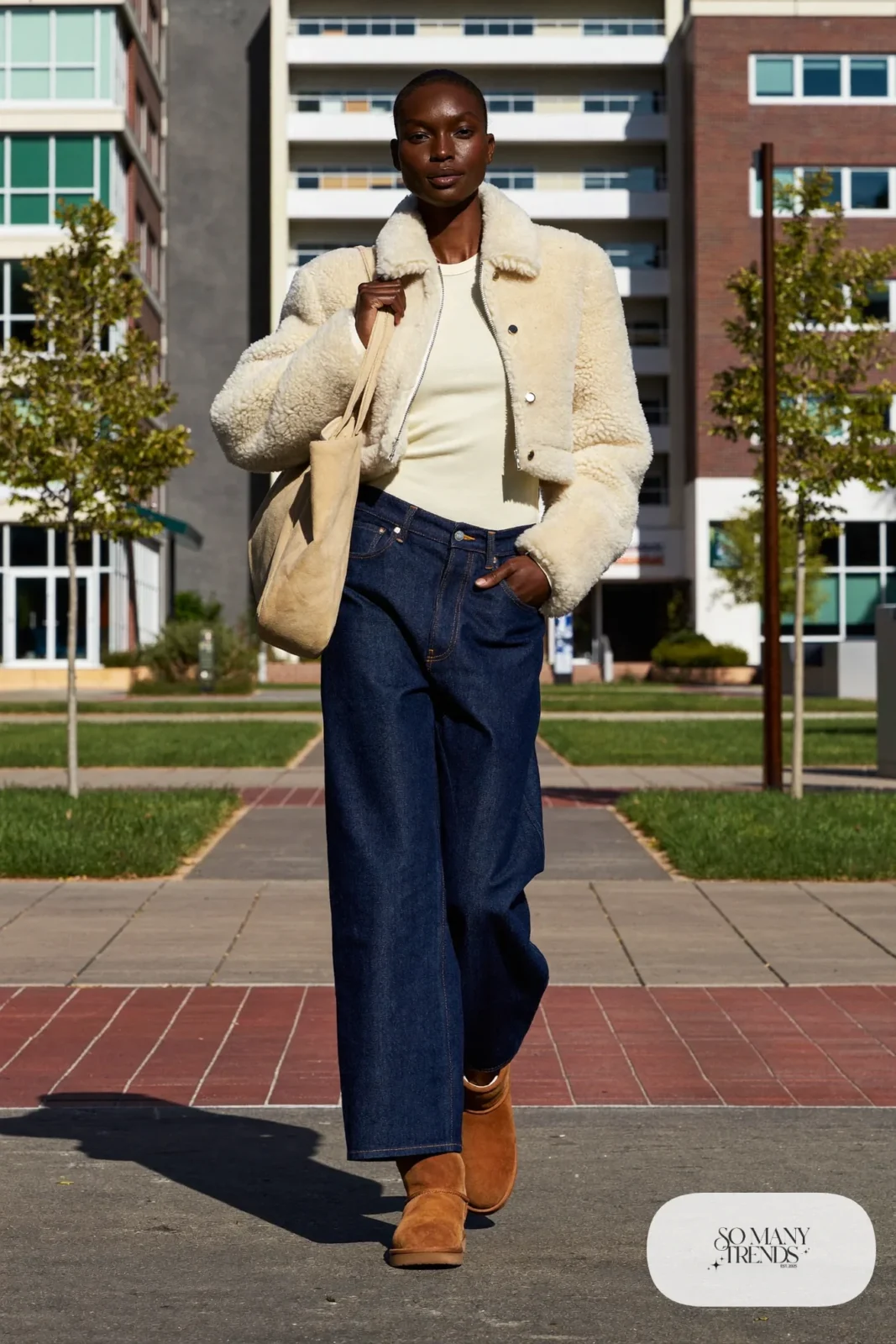 Woman in dark wide-leg jeans, cream tee, cropped shearling jacket and chestnut Ugg mini boots, outfit 9