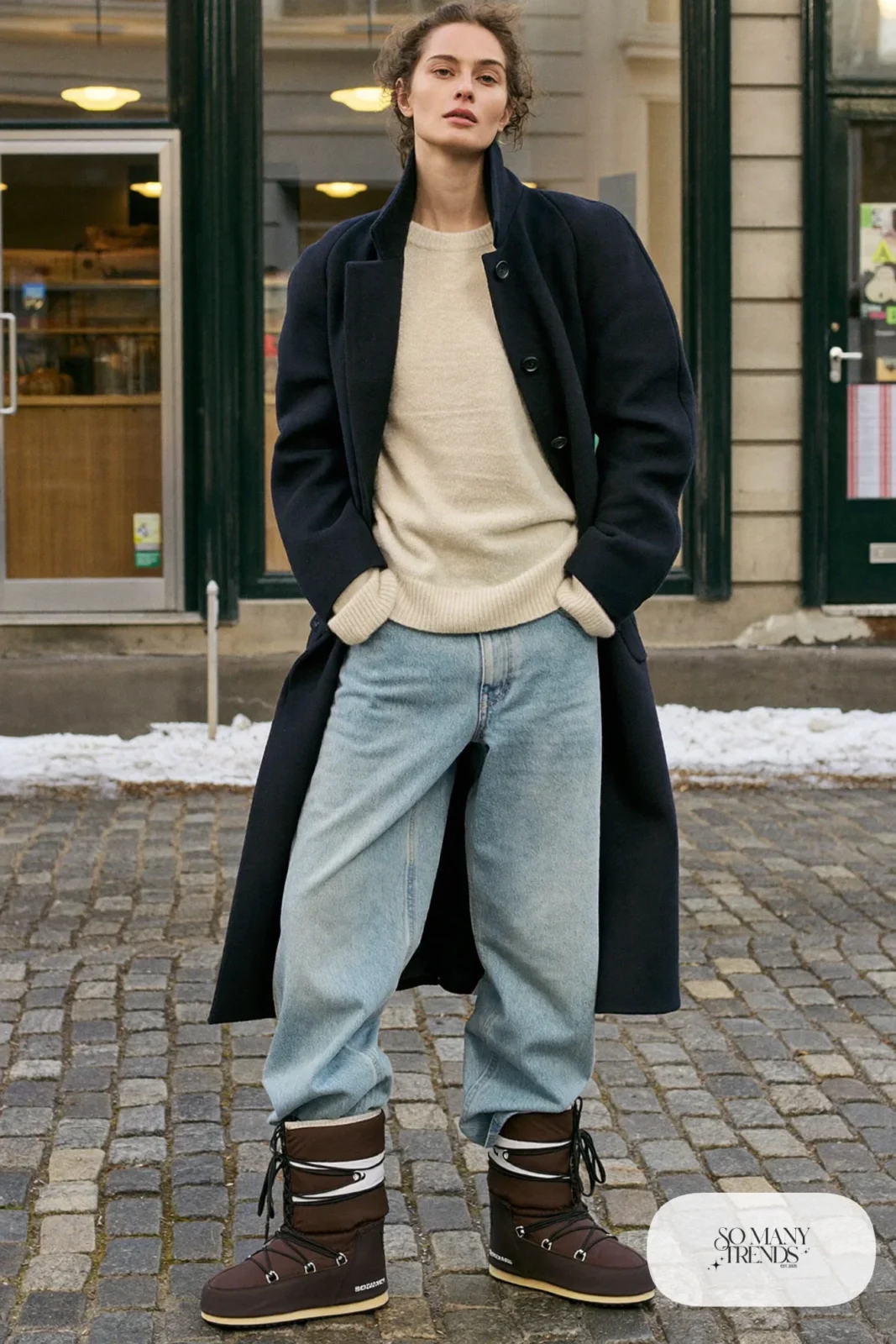 Woman in a navy wool coat, light wide-leg jeans, ivory sweater and chocolate Sorel boots, outfit 5